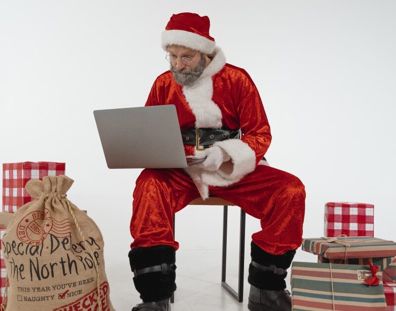 santa clause on a laptop looking at tech gifts