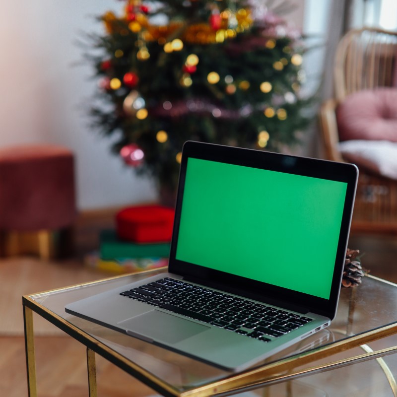 computer in front of christmas tree for tech gifts