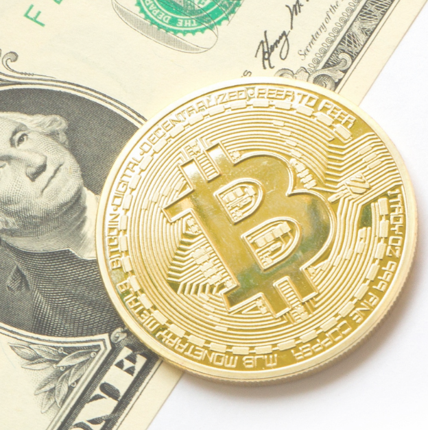 bitcoin next to dollar bill