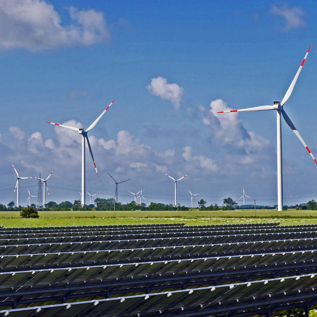 renewable energy farm with windmills and solar panels