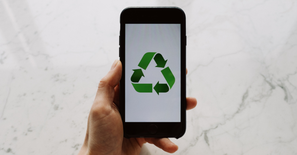 electronics recycling and e-waste disposal symbolized by phone with recycle logo on screen